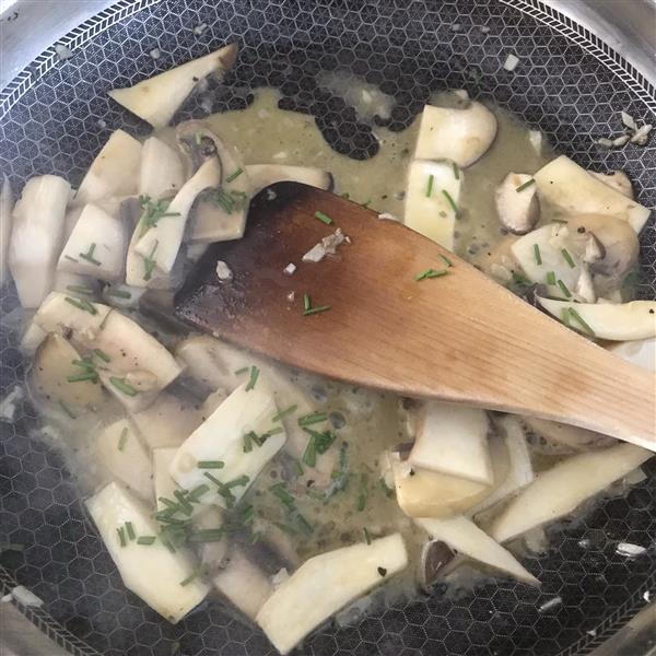 Add chopped chives to garlic butter mushrooms